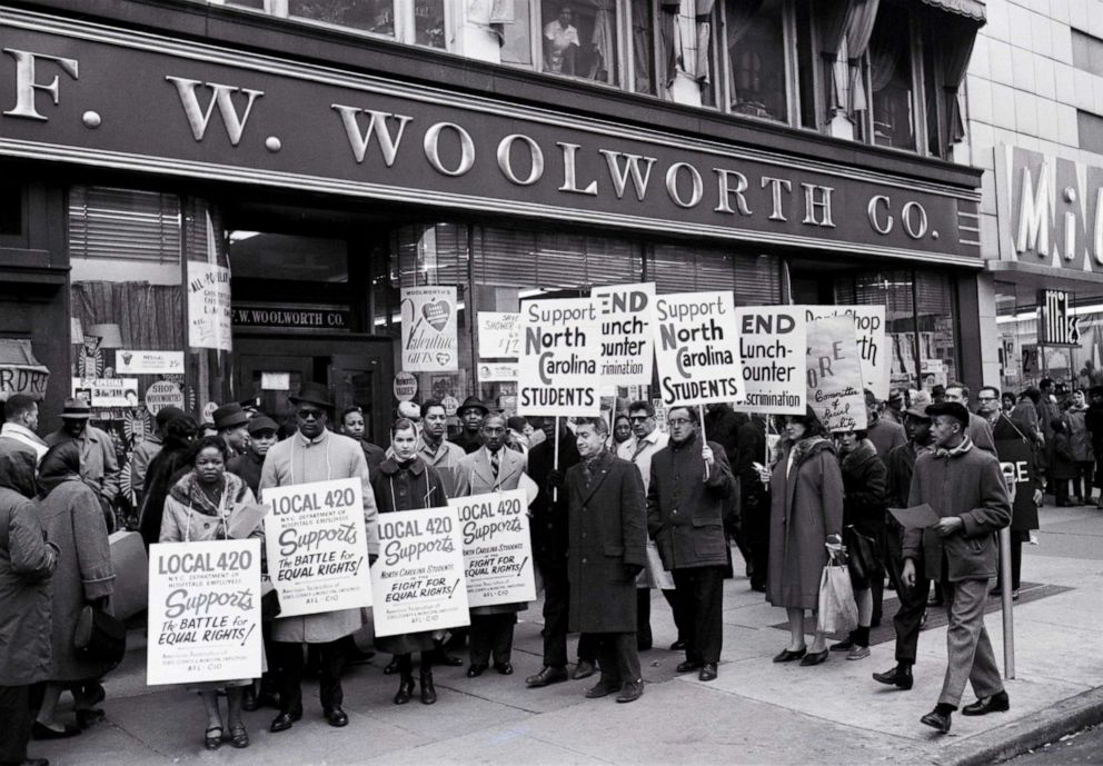 PHOTO: Demonstrators gather in front of a Woolworth store in Harlem, Feb. 13, 1960, to protest lunch counter discrimination in Greensboro, Charlotte and Durham, North Carolina. 