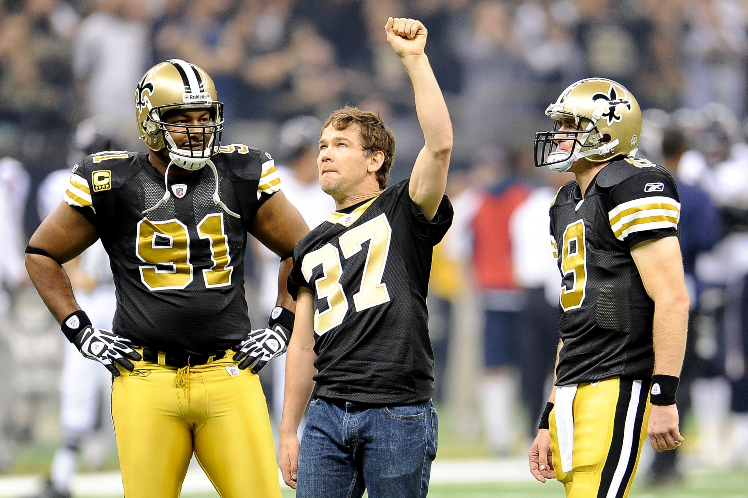 PHOTO: Will Smith #91 and Drew Brees #9 of the New Orleans Saints stand with former Saint Steve Gleason during a game at the Louisiana Superdome, Sept. 25, 2011, in New Orleans, Louisiana.