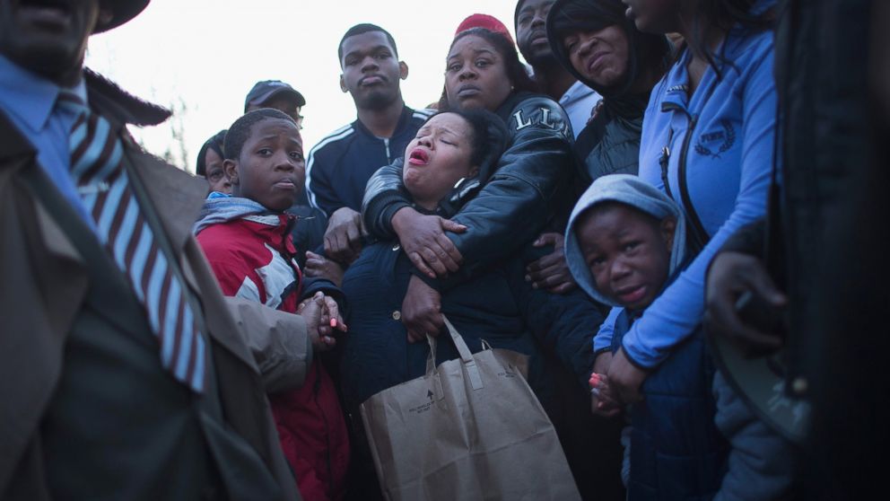 Tambrasha Hudson (C) is comforted as she joins demonstrators protesting the shooting death of her son 16-year-old Pierre Loury near the location where he was killed on April 12, 2016 in Chicago. 
