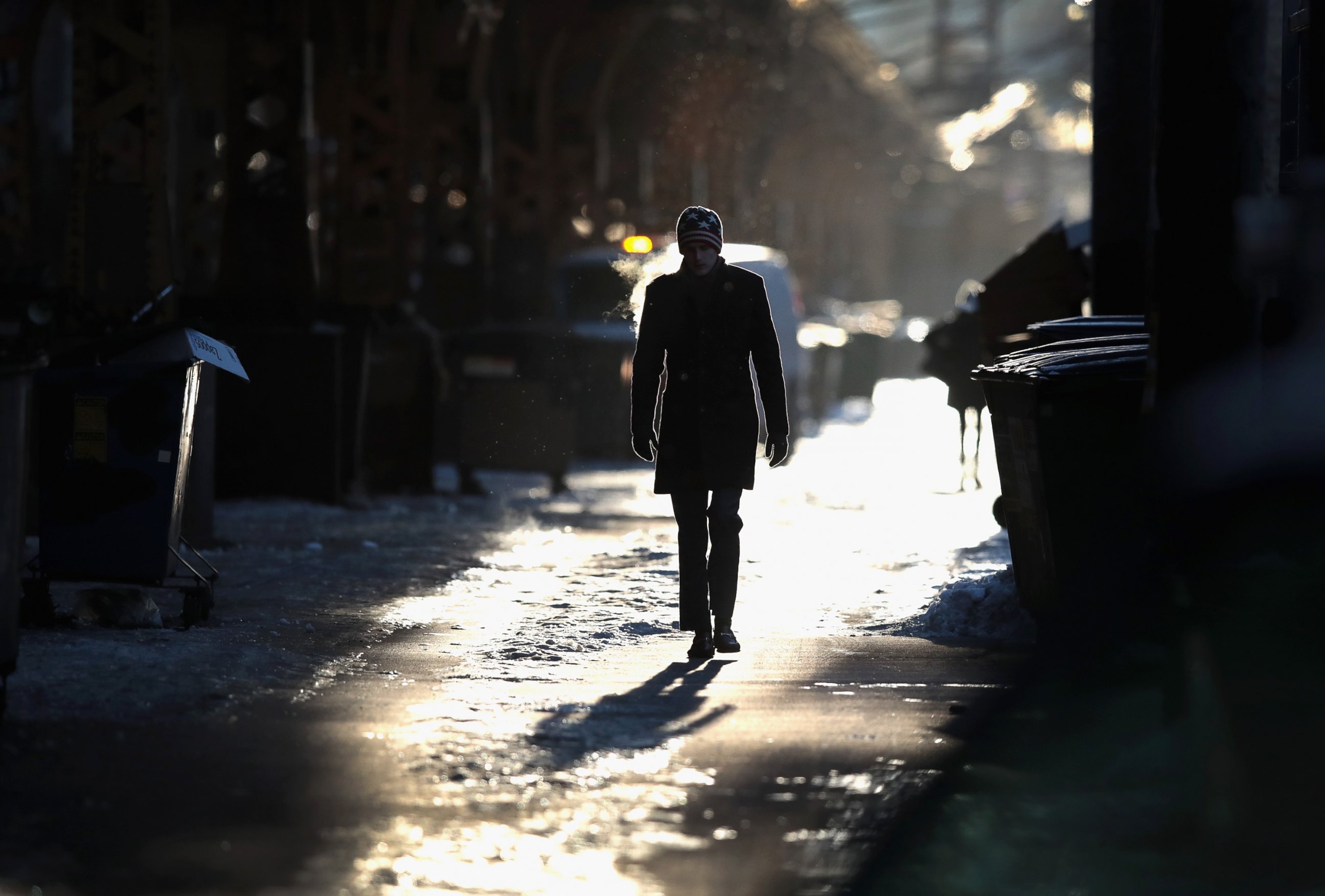 PHOTO: A man walks down an ice and snow covered alley toward an L station, Dec. 15, 2016, in Chicago, Illinois.