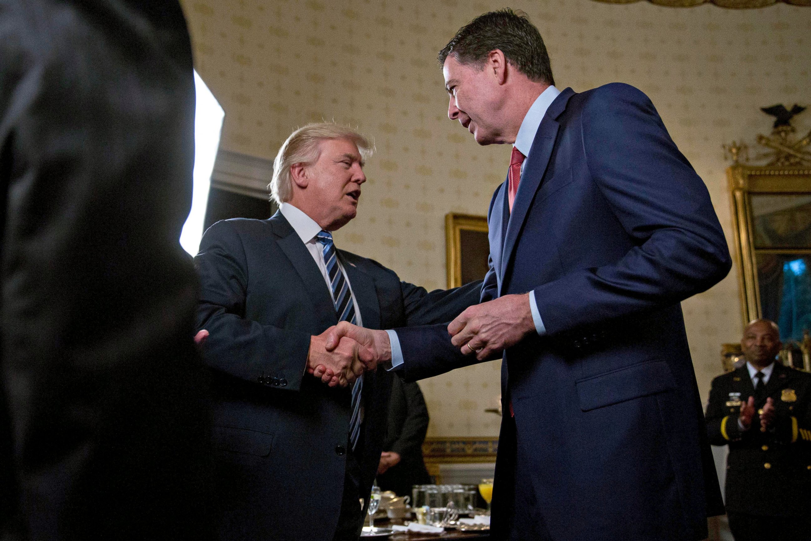 PHOTO: President Donald Trump shakes hands with James Comey, director of the Federal Bureau of Investigation, during an Inaugural Law Enforcement Officers and First Responders Reception in the Blue Room of the White House, Jan. 22, 2017, in Washington.