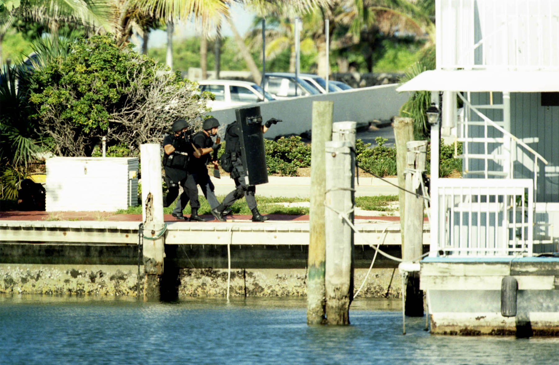 PHOTO: Members of the Miami-Dade Swat team storm a Miami Beach boat house containing serial killer Andrew Cunanan, July 23, 1997. 