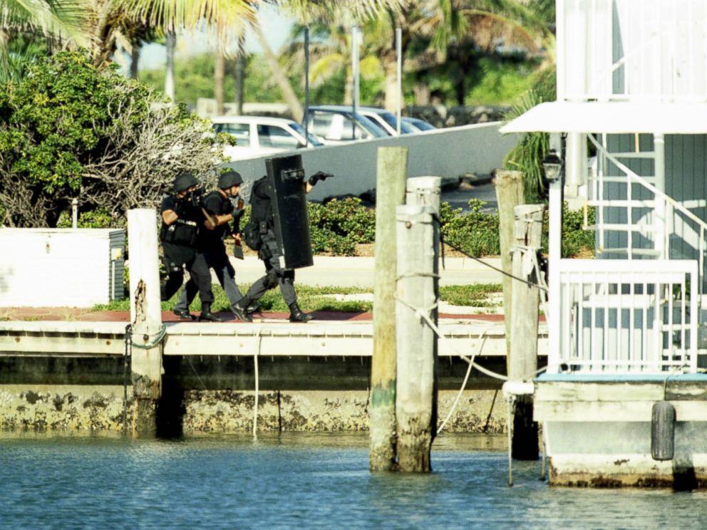 PHOTO: Members of the Miami-Dade Swat team storm a Miami Beach boat house containing serial killer Andrew Cunanan, July 23, 1997.