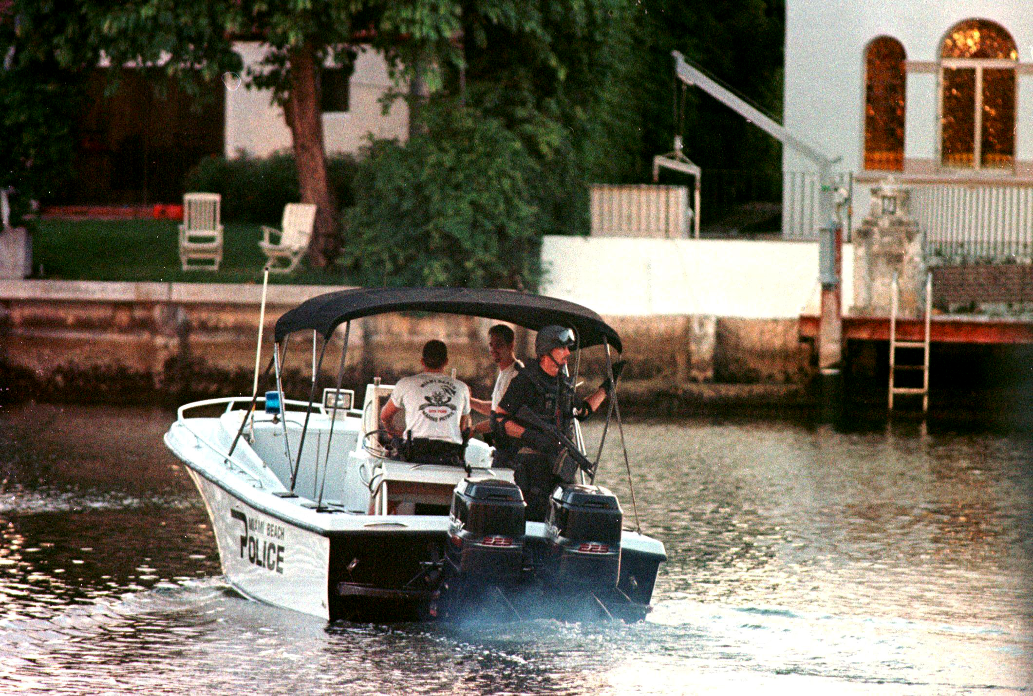 PHOTO: A member of the Miami Beach police SWAT team patrols a canal in the vicinity of a houseboat in Miami Beach, Fla., July 23, 1997, after it was reported that an unknown person was seen inside by the houseboat's caretaker.