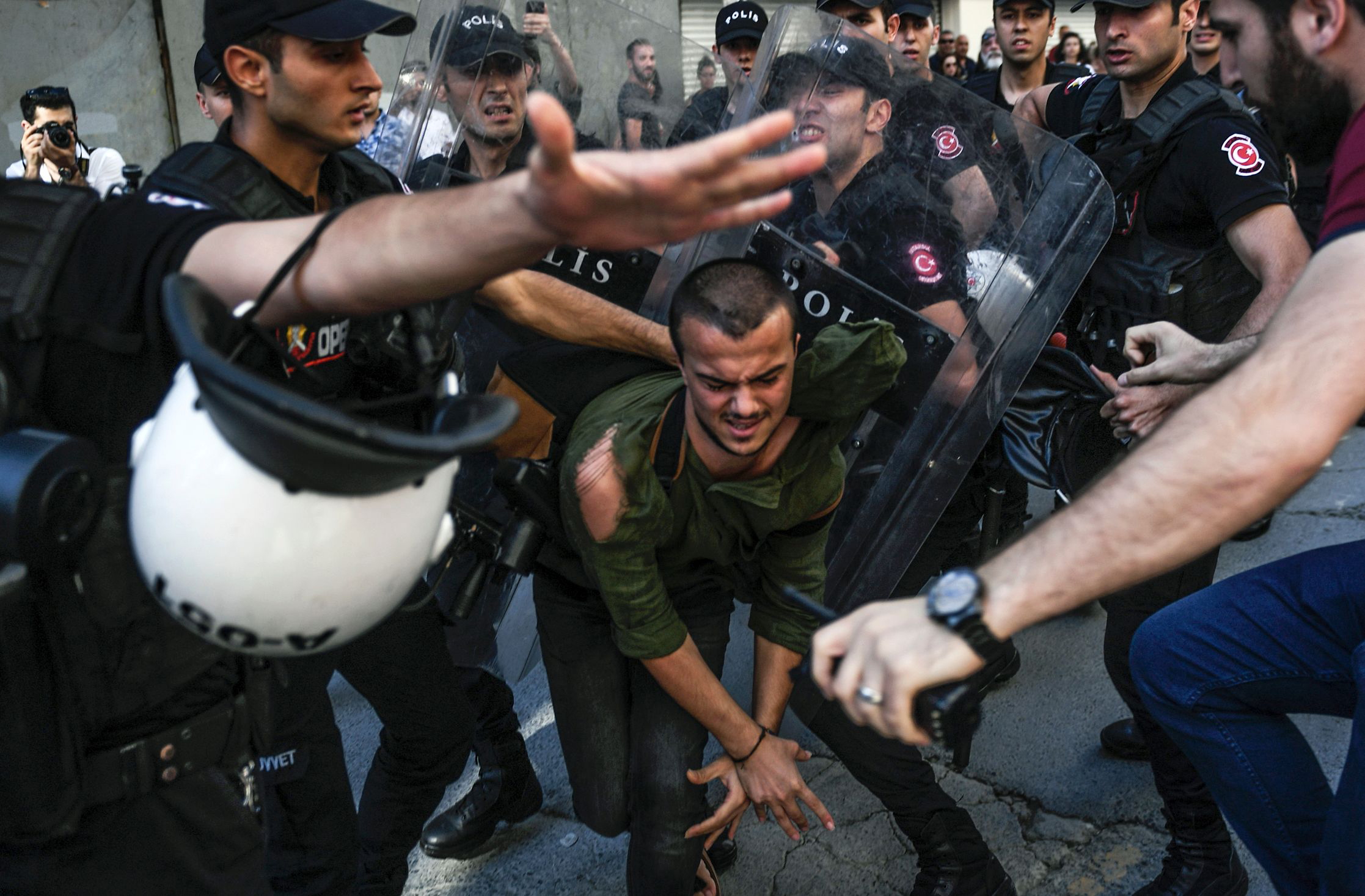 PHOTO: A plain-clothes police officer kicks a member of a group of LGBT rights activist as Turkish police prevent them from going ahead with a Gay Pride annual parade on June 25, 2017 in Istanbul, a day after it was banned by the city governor's office.