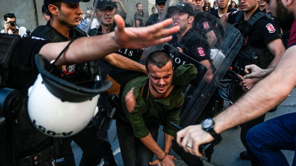 PHOTO: A plain-clothes police officer kicks a member of a group of LGBT rights activist as Turkish police prevent them from going ahead with a Gay Pride annual parade on June 25, 2017 in Istanbul, a day after it was banned by the city governor's office.