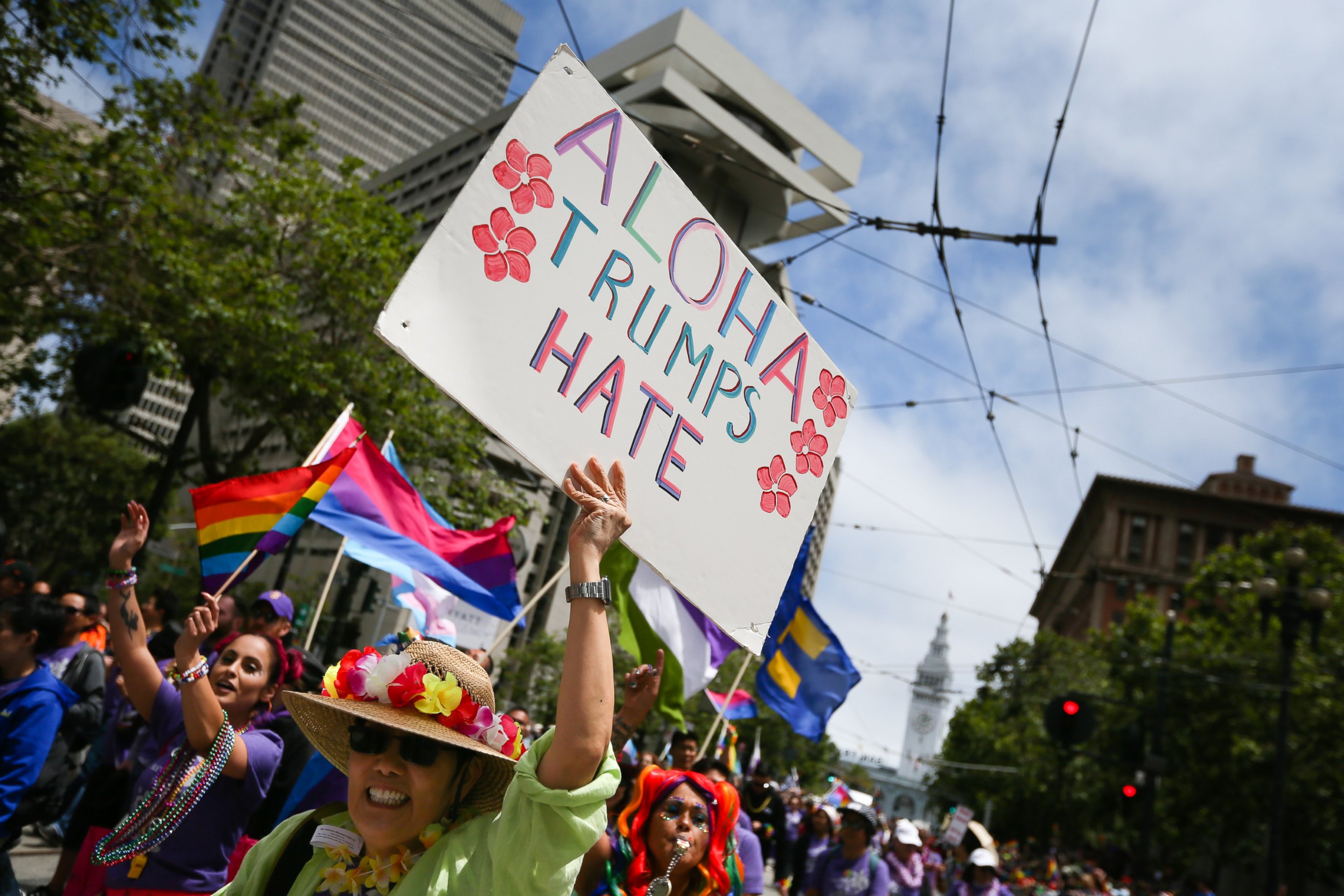 PHOTO: A woman holds a sign saying 'Aloha Trumps Hate' while participating in the annual LGBTQI Pride Parade, June 25, 2017 in San Francisco. The LGBT community descended on Market Street for the 47th annual Pride Parade.