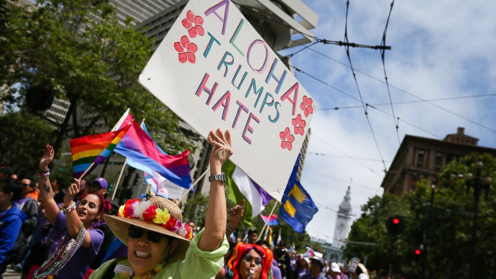PHOTO: A woman holds a sign saying 'Aloha Trumps Hate' while participating in the annual LGBTQI Pride Parade, June 25, 2017 in San Francisco. The LGBT community descended on Market Street for the 47th annual Pride Parade.