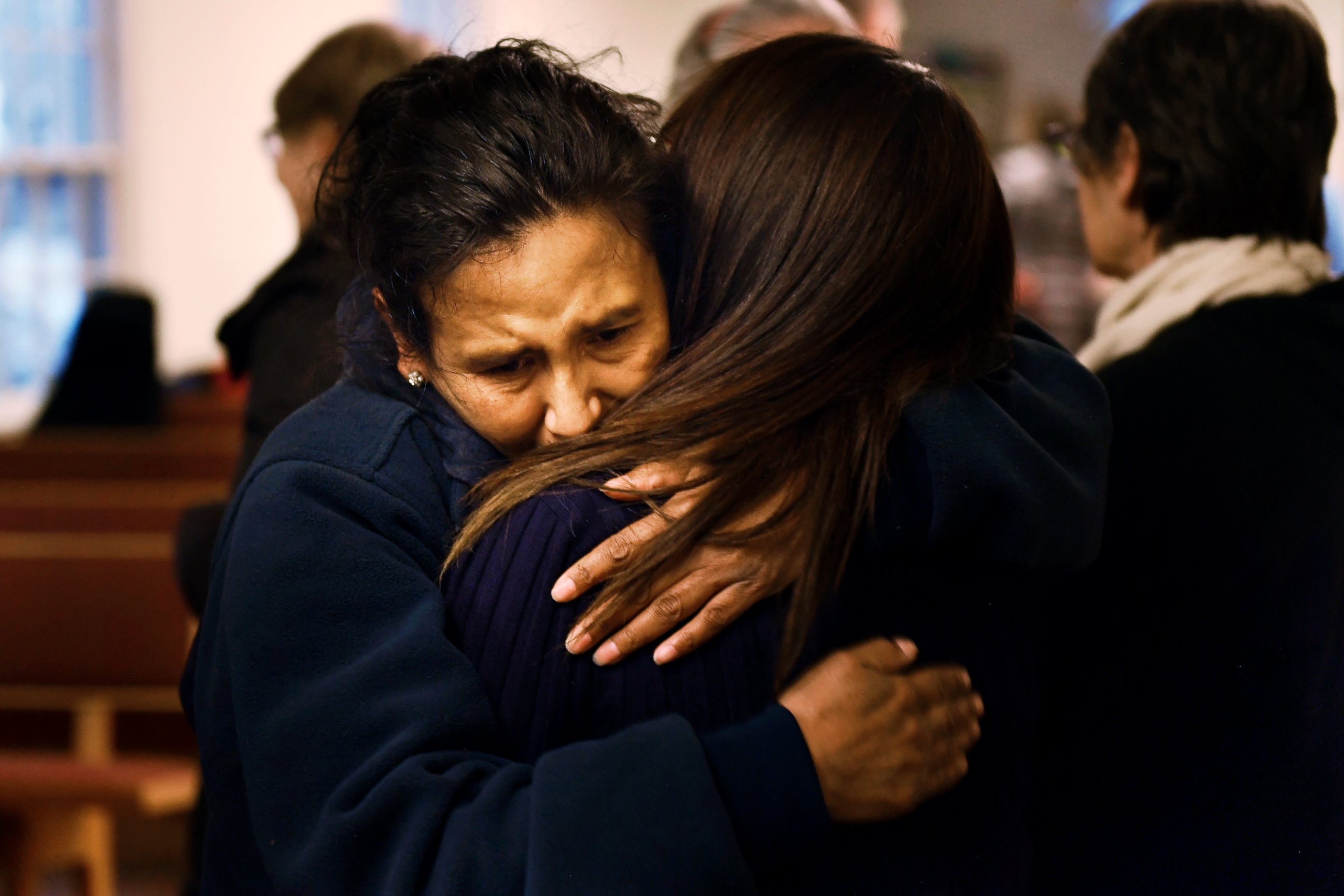 PHOTO: Jeanette Vizguerra hugs her friend Ingrid Encalada Latorre after Latorre announces her claim of Sanctuary at a Mountain View Friends Meeting.