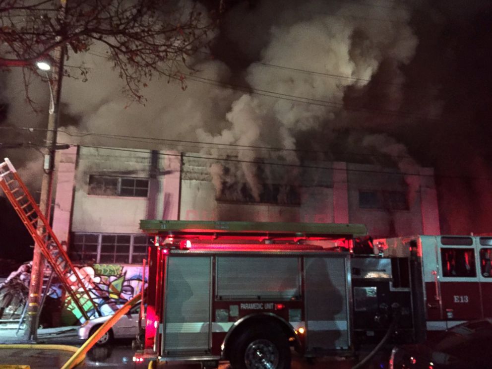 PHOTO: Smoke pours from a warehouse, which caught fire during a dance party in Oakland, California, Dec. 3, 2016. 