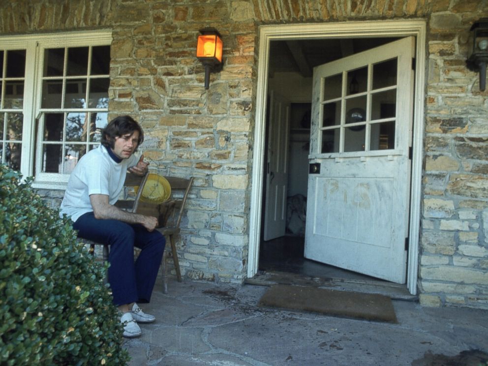 PHOTO: Director Roman Polanski sitting outside his home after the murder of his wife Sharon Tate, Aug. 1, 1969. The word PIG was scrawled on door.