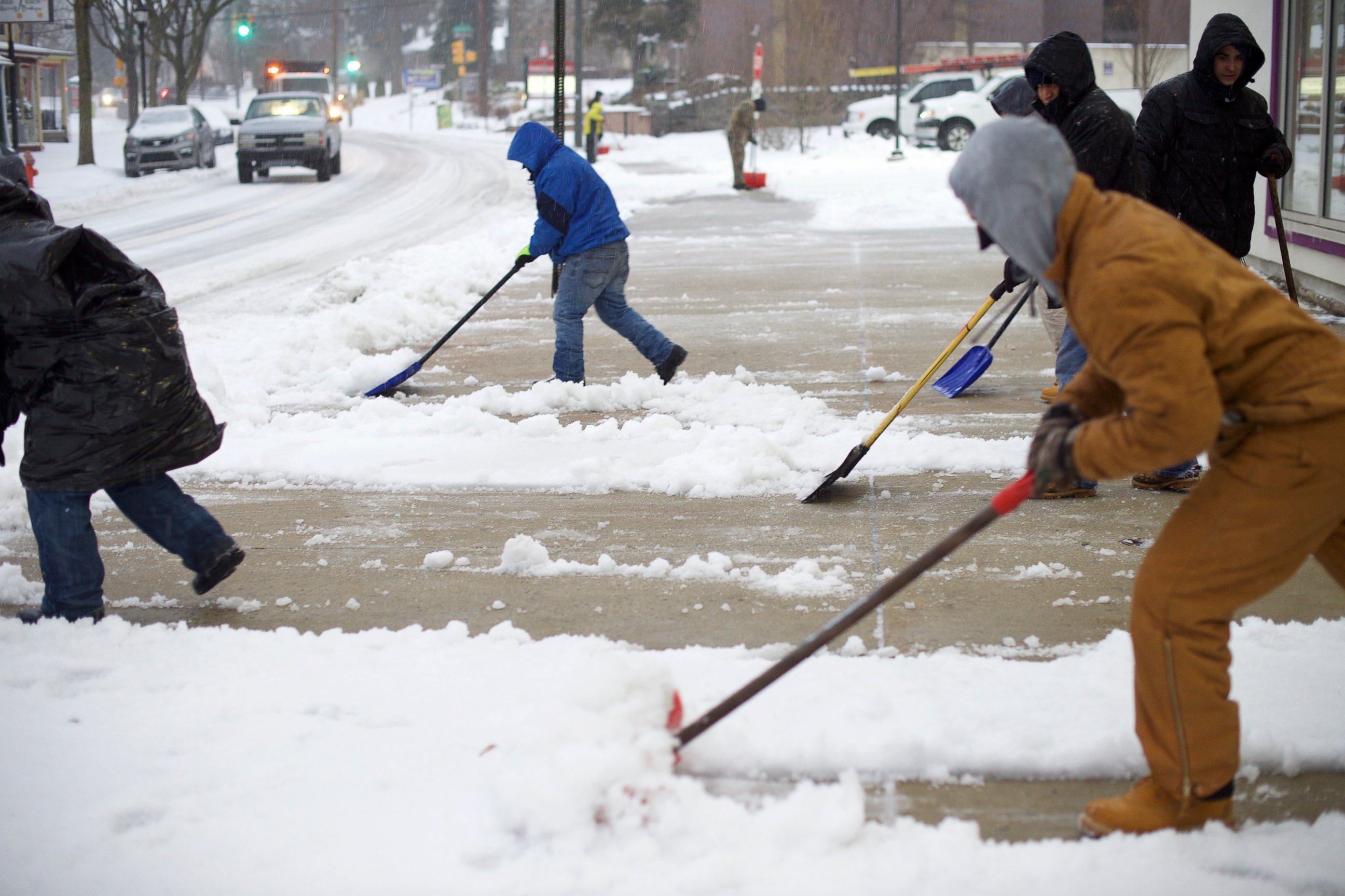 PHOTO: Men shovel a sidewalk March 14, 2017 in the Roxborough area of Philadelphia.