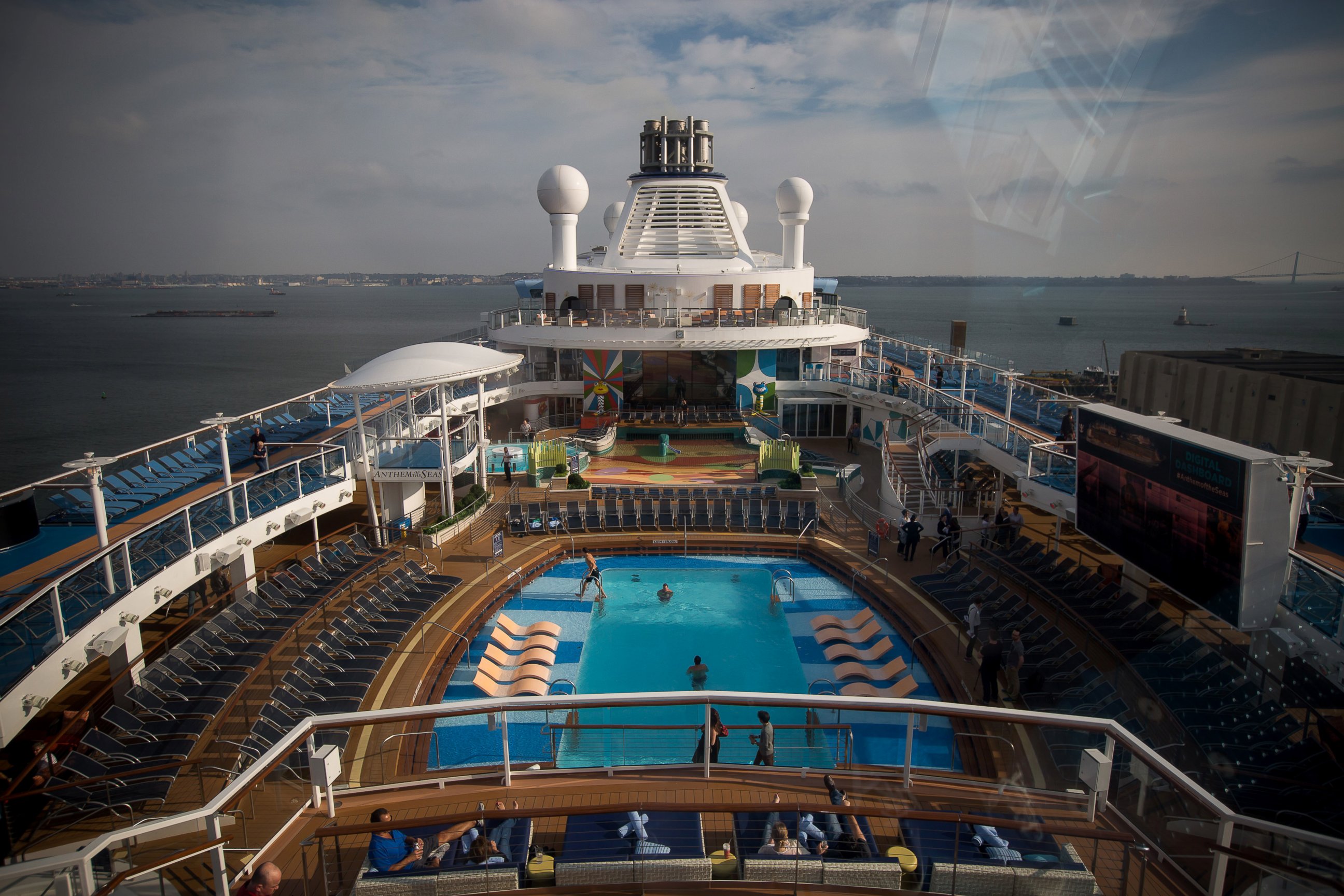 PHOTO: Guests relax on the deck of the Royal Caribbean Cruises Ltd. Quantum-class cruise ship, the Anthem of the Sea, at the Cape Liberty Cruise Port in Bayonne, N.J. on Oct. 6, 2015. 