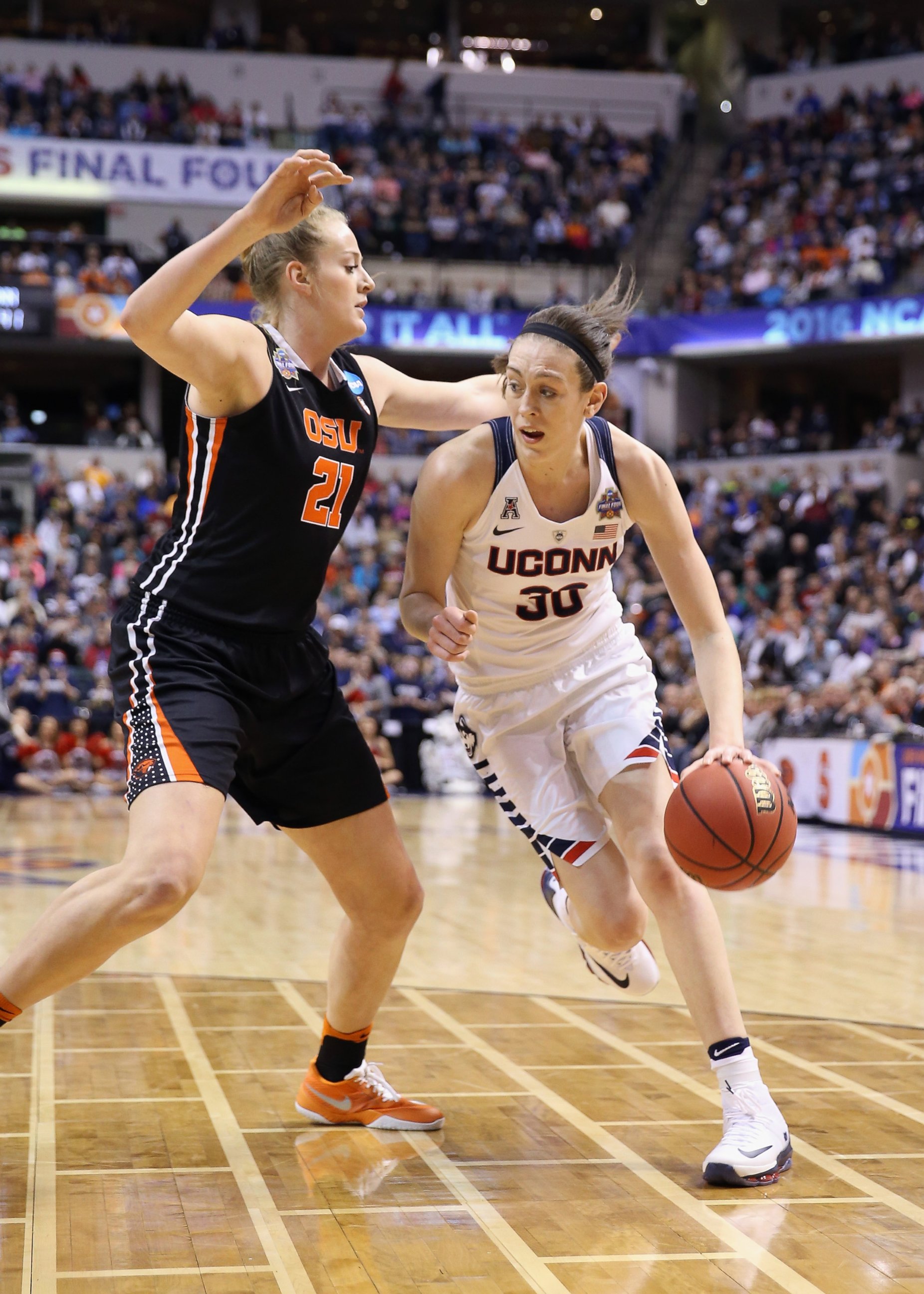 PHOTO: Breanna Stewart (30) of the Connecticut Huskies drives against Marie Gulich (21) of the Oregon State Beavers in the second quarter during the semifinals of the 2016 NCAA Women's Final Four Basketball Championship on April 3, 2016 in Indianapolis.