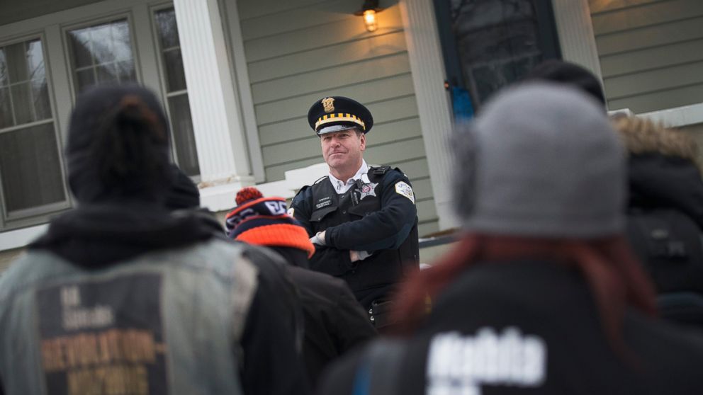 Protestors confront police guarding Mayor Rahm Emanuel's home on Dec. 29, 2015 in Chicago.