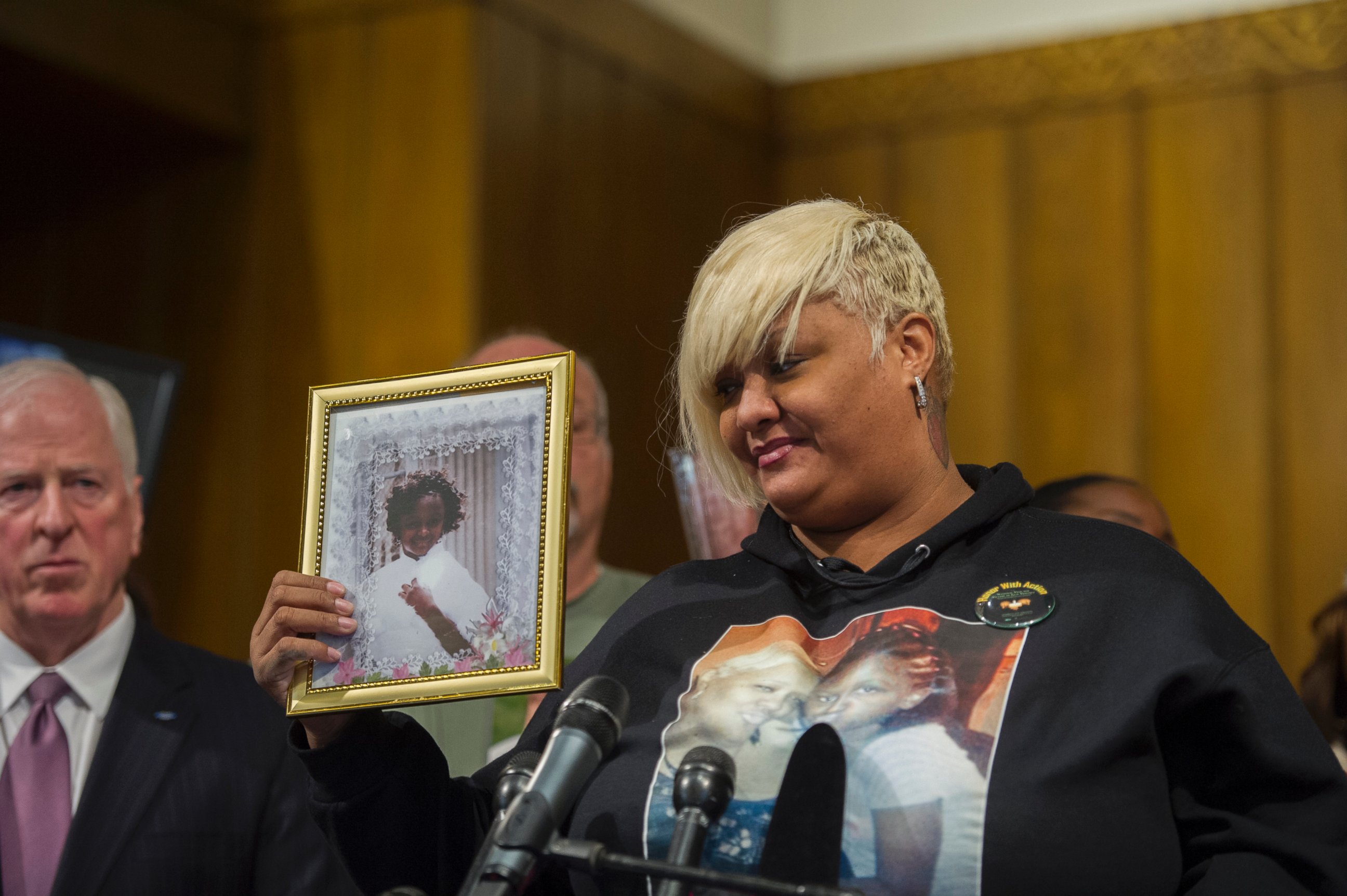 PHOTO: WASHINGTON, DC - DECEMBER 11: Ashake Banks, of Chicago Illinois, introduces herself to the audience as she holds a photo of her daughter Heaven Sutton, 7, who was shot by a stray bullet on Chicago's west side on June 27, 2012.
