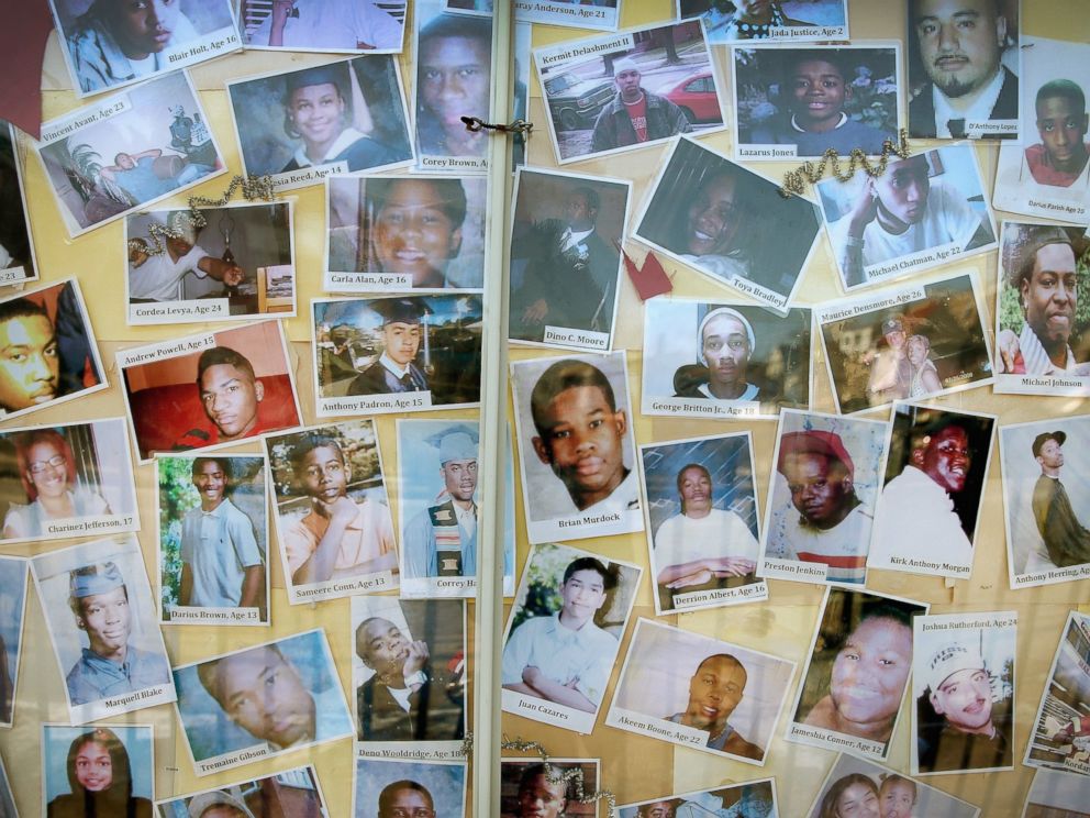 PHOTO: CHICAGO, IL - DECEMBER 23: Pictures of Chicago residents who have died by gunfire are posted next to a Christmas tree outside Saint Sabina Church in the Auburn Gresham neighborhood on the citys Southside on December 23, 2013 in Chicago, Illinois.
