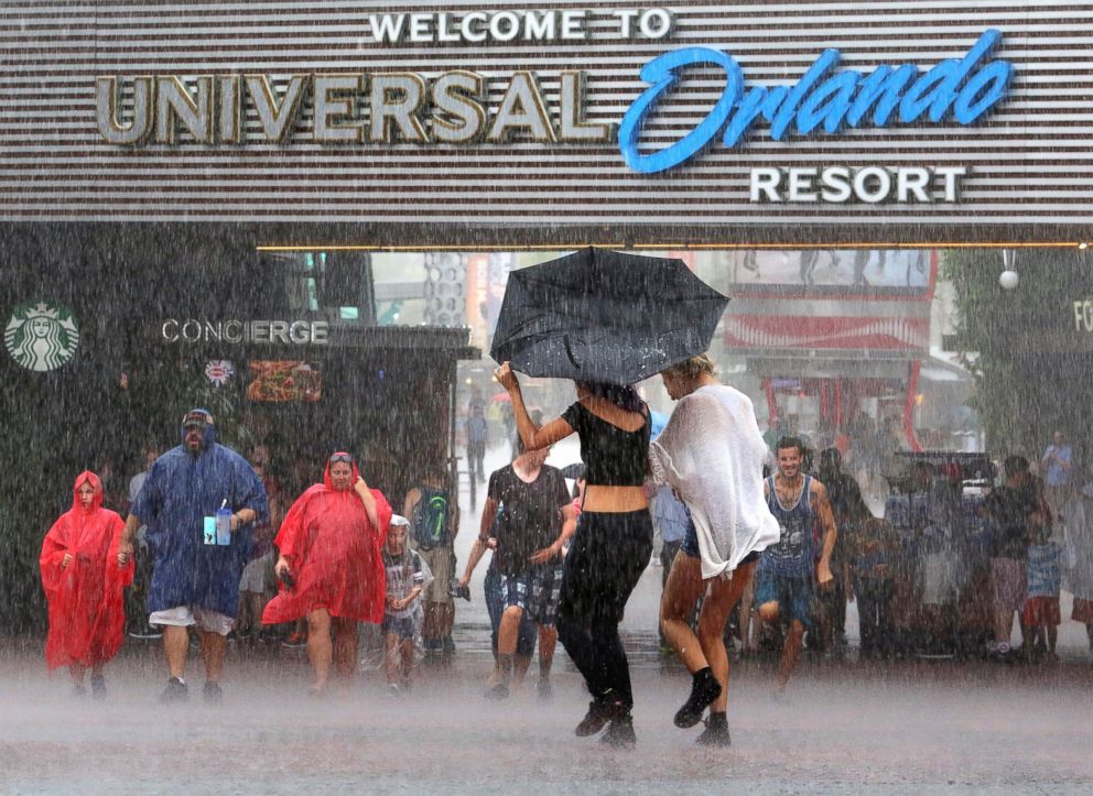 PHOTO: Guests arriving at the Universal Orlando theme park complex are welcomed at CityWalk with the first rain band, at 2:04pm, from Tropical Storm Colin on June 6, 2016.
