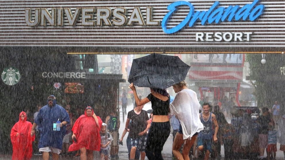 PHOTO: Guests arriving at the Universal Orlando theme park complex are welcomed at CityWalk with the first rain band, at 2:04pm, from Tropical Storm Colin on June 6, 2016.