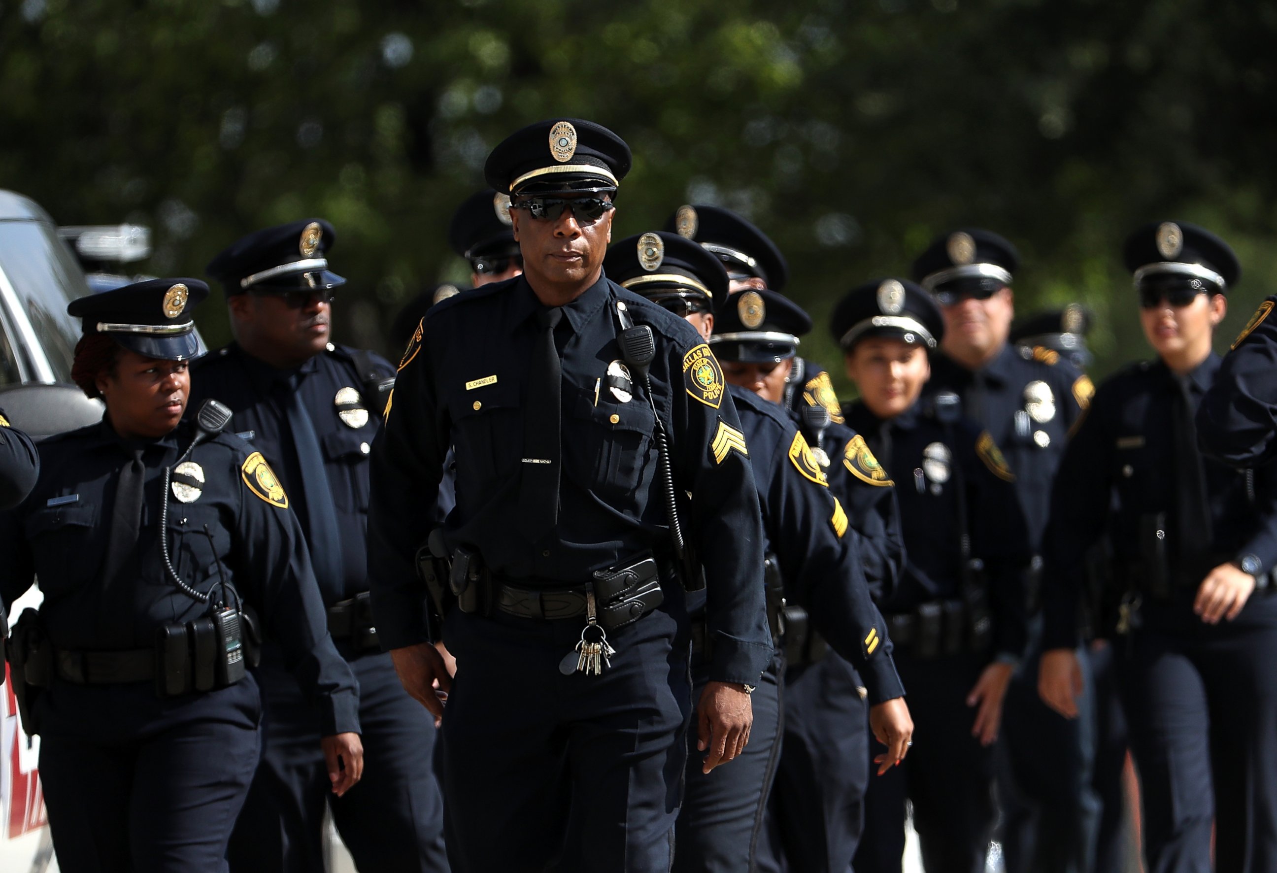 PHOTO: Police officers arrive at a funeral service for slain Dallas Area Rapid Transit (DART) police officer Brent Thompson at the Potter House Church on July 13, 2016 in Dallas.
