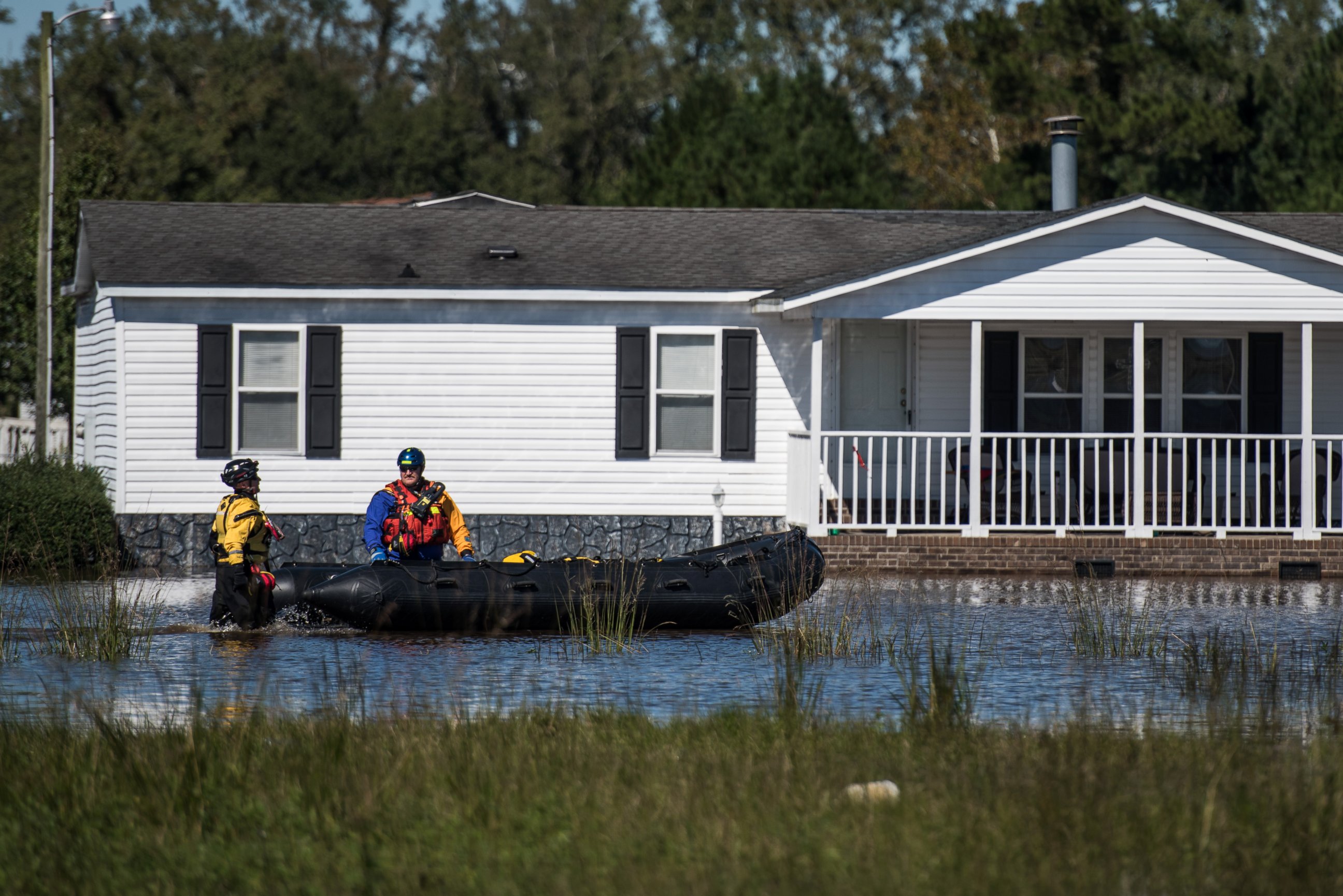 PHOTO: Rescue workers navigate floodwaters in a neighborhood, on Oct. 10, 2016, in Lumberton, North Carolina. 