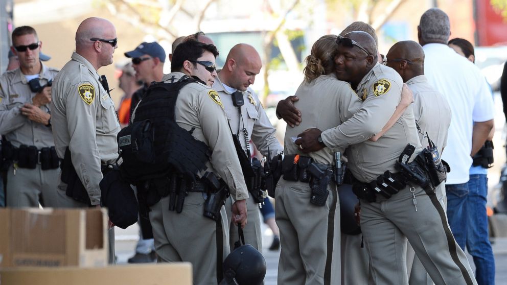 PHOTO: Las Vegas Metropolitan Police Department officers hug near a Wal-Mart on June 8, 2014 in Las Vegas, Nevada. Two officers were reported shot and killed by two assailants at a pizza restaurant near the Wal-Mart. 