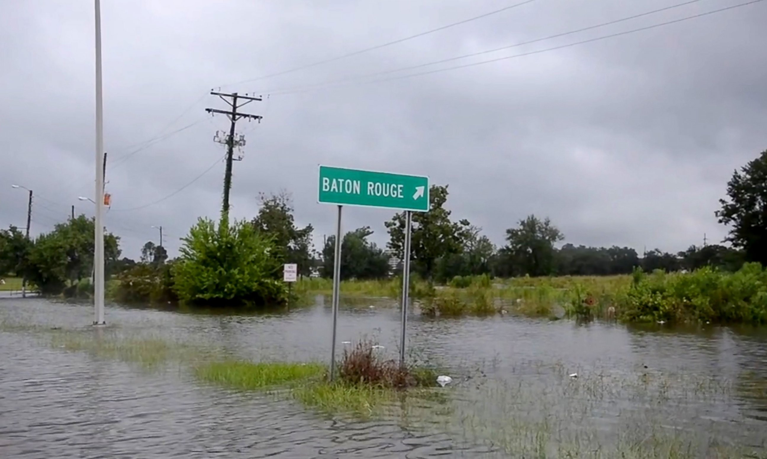 PHOTO: This Aug. 14, 2016 image from video provided by the Louisiana Army and Air National Guard shows floodwaters surrounding a road sign in Baton Rouge, Louisiana.
