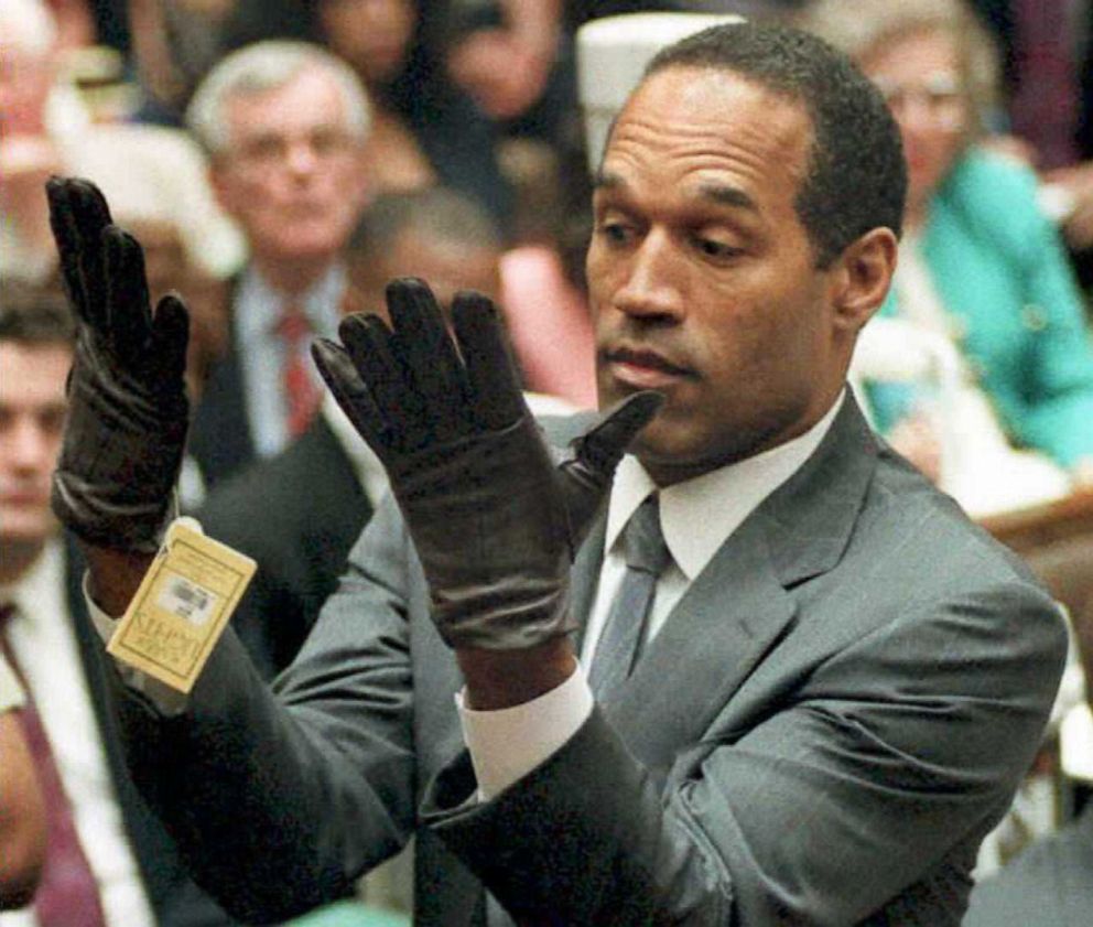 PHOTO: O.J. Simpson looks at a new pair of Aris extra-large gloves that prosecutors had him put on June 21,1995 during his double-murder trial in Los Angeles.