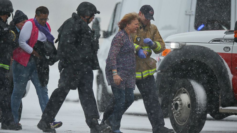 COLORADO SPRINGS, CO - NOVEMBER 27:  Hostages are escorted to safety during an active shooter situation outside a Planned Parenthood facility where an active shooter reportedly injured up to eleven people, including at least five police officers, on November 27, 2015 in Colorado Springs, Colorado. Police are working to clear the scene and are searching the buiding for possible explosive devices.