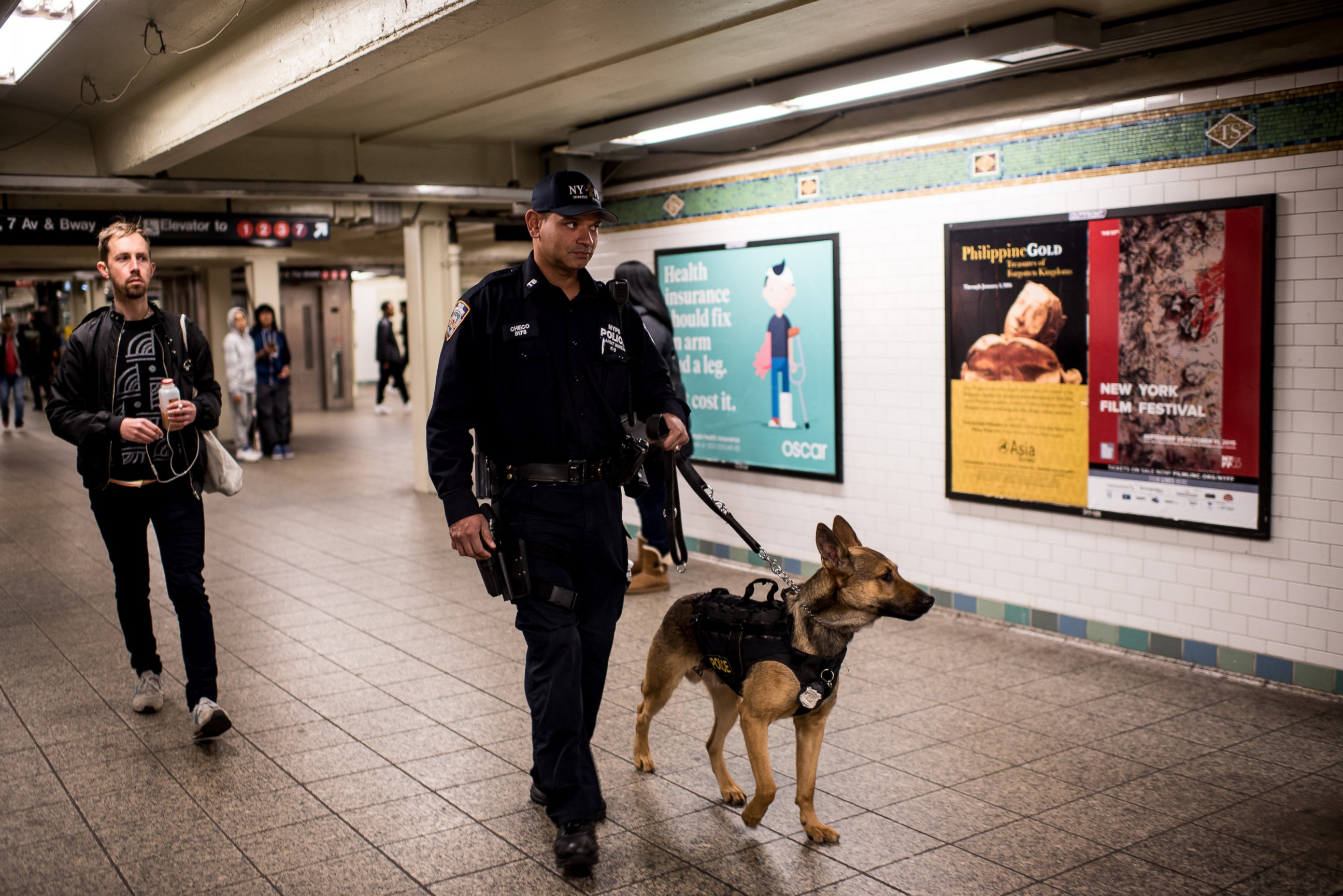 PHOTO: A police officer patrols the Times Square subway stop with his dog following a series of terrorist attacks in Paris on Nov. 14, 2015 in New York City. 