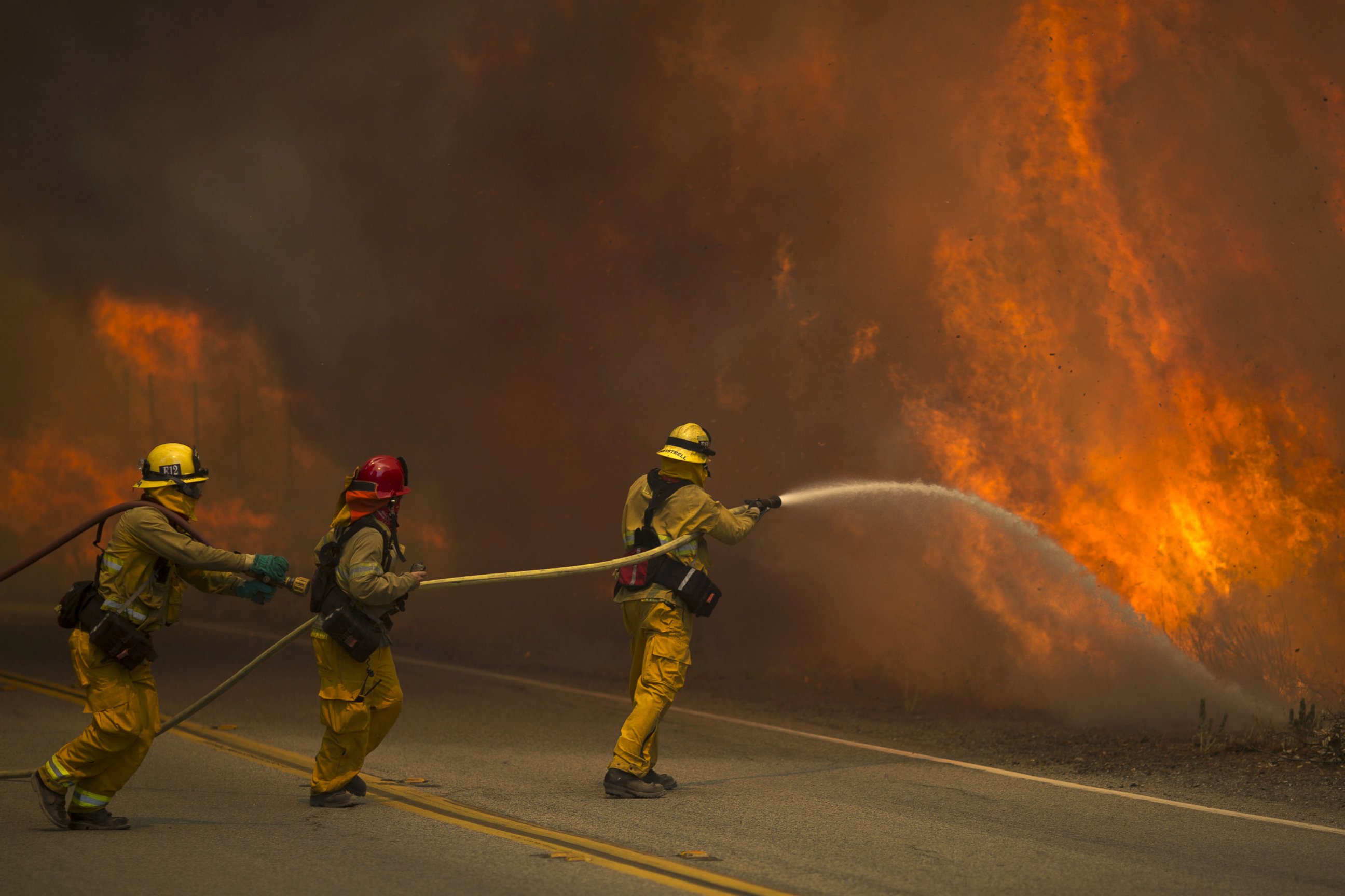 PHOTO: Firefighters battle flames in Placerita Canyon at the Sand Fire, on July 24, 2016, in Santa Clarita, California.