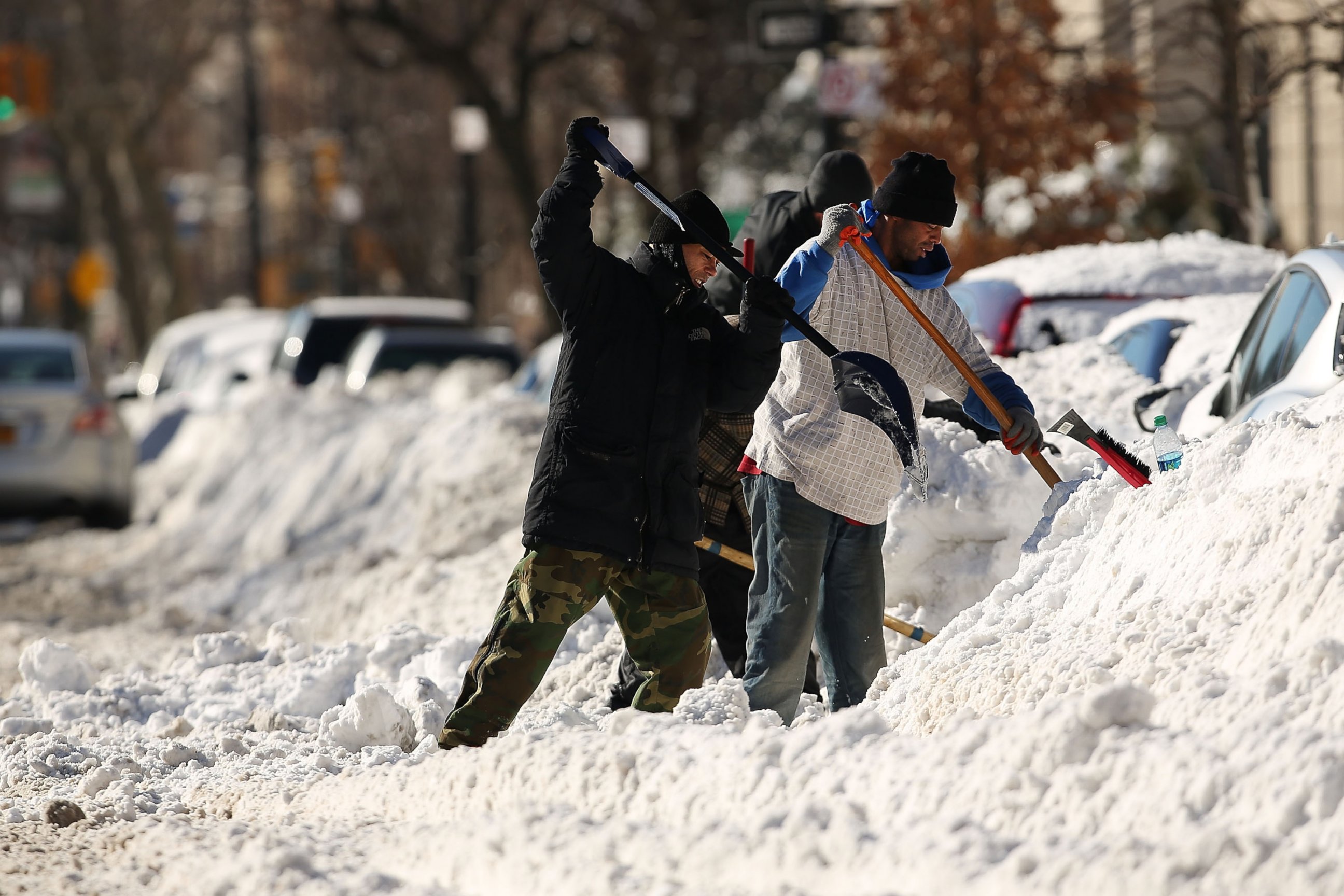 PHOTO:People dig out cars on a sunny day following a blizzard in the Brooklyn borough of New York, Jan. 24, 2016.
