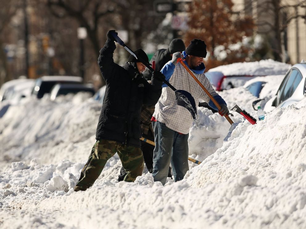 PHOTO:People dig out cars on a sunny day following a blizzard in the Brooklyn borough of New York, Jan. 24, 2016.