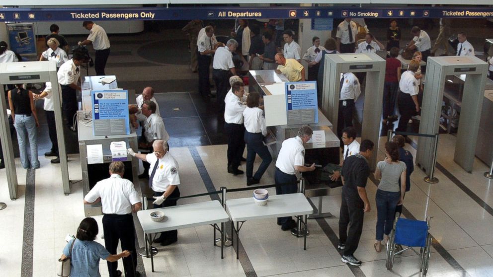 Travelers pass through a security checkpoint manned with new Transportation Security Agency employees in Terminal 5/International Departures at O'Hare International Airport August 6, 2002 in Chicago, Illinois.