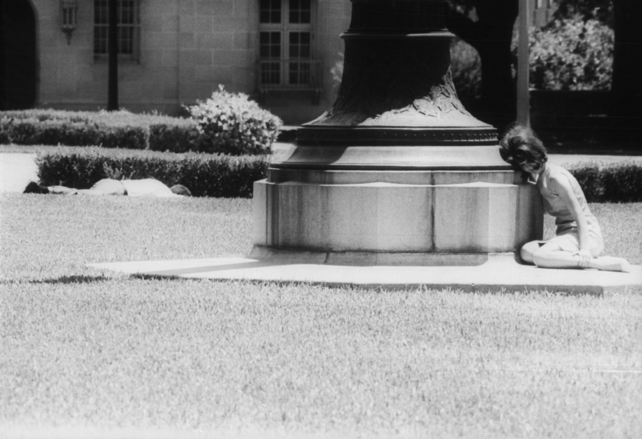 PHOTO: A woman cowers in fear behind a statue while a man lies wounded a few feet away, victim of sniper Charles Whitman, Aug. 1, 1966, in Austin, Texas. 