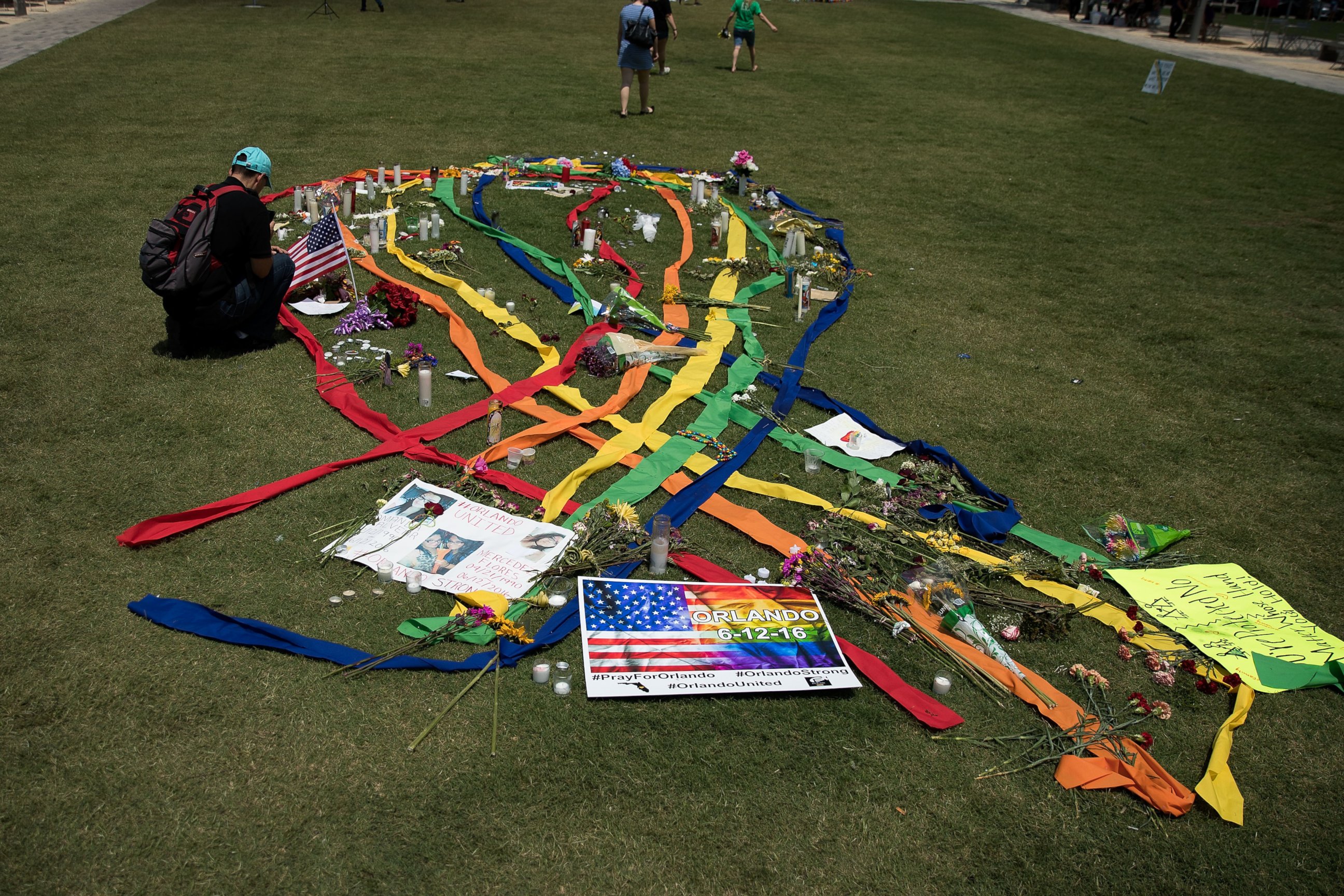 PHOTO: A gay pride ribbon is displayed on the lawn of the Dr. Phillips Performing Arts Center, near a makeshift memorial for the victims of the Pulse Nightclub shooting June 14, 2016 in Orlando, Florida.