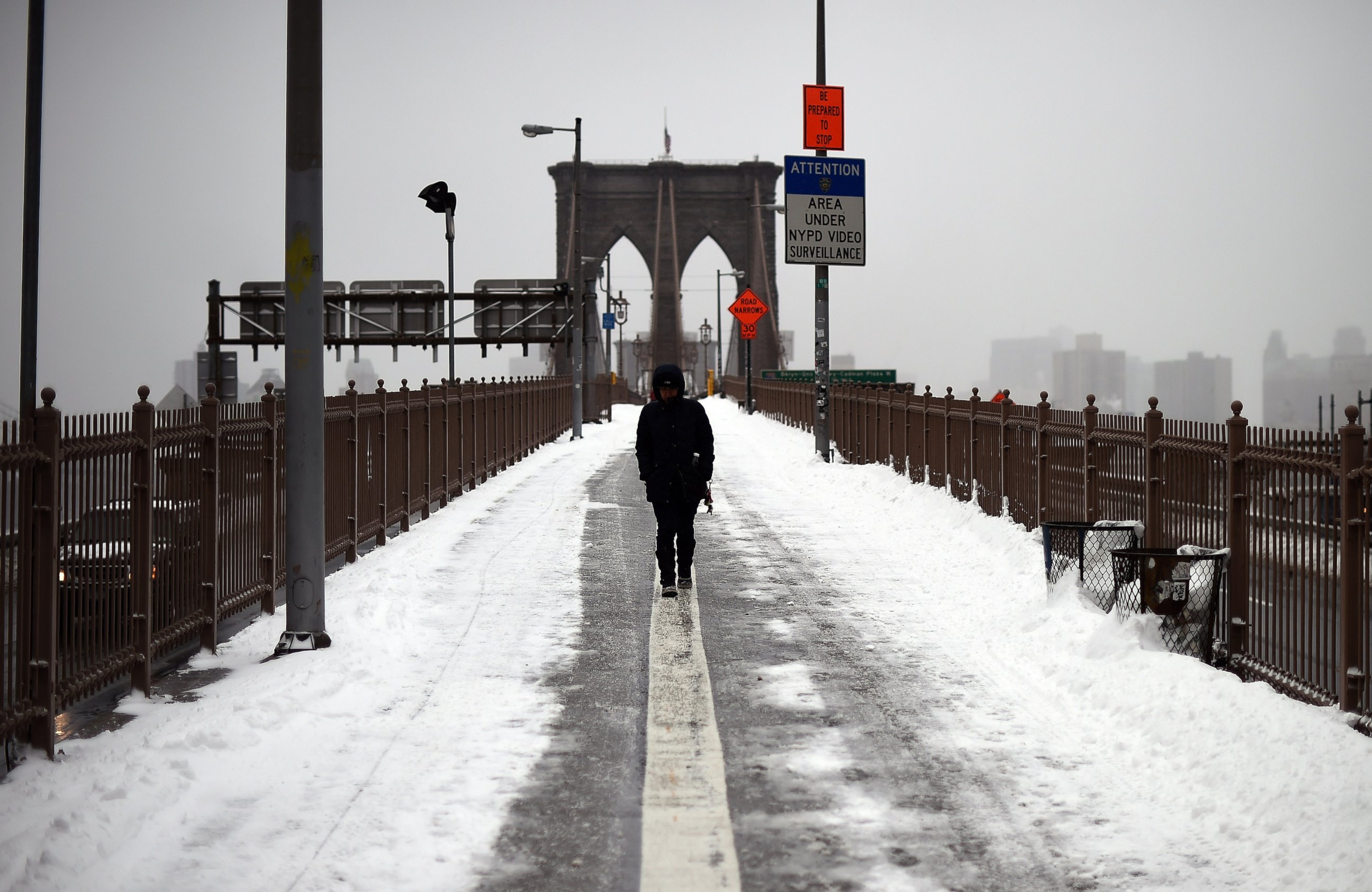 PHOTO: A woman walks on the Brooklyn Bridge in New York after a snowstorm on January 27, 2015. A blizzard initially billed as possibly one of the worst ever in New York left only moderate snow in the Big Apple.