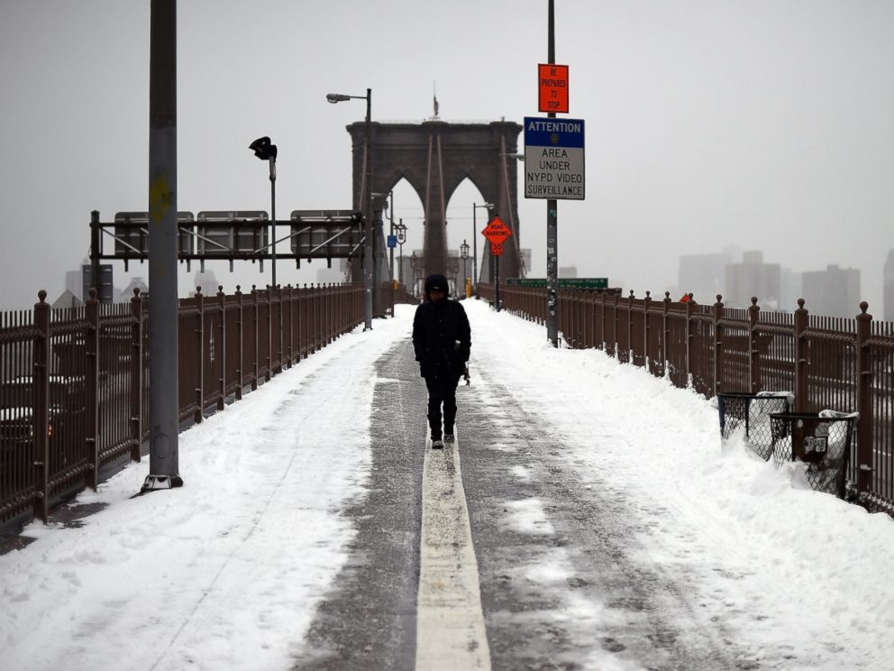 PHOTO: A woman walks on the Brooklyn Bridge in New York after a snowstorm on January 27, 2015. A blizzard initially billed as possibly one of the worst ever in New York left only moderate snow in the Big Apple.