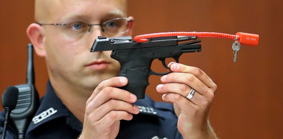 PHOTO: Sanford police officer Timothy Smith holds up the gun that was used to kill Trayvon Martin, while testifying on the 15th day of the George Zimmerman murder trial in Seminole circuit court June 28, 2013 in Sanford, Florida.
