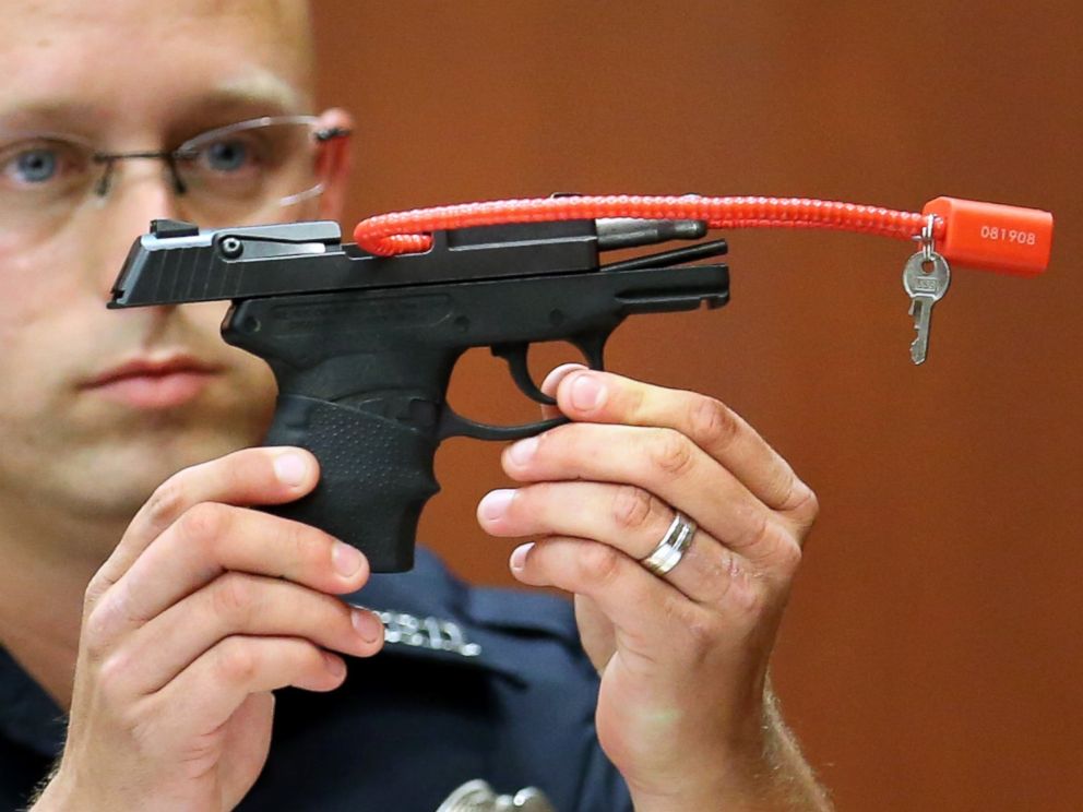 PHOTO: Sanford police officer Timothy Smith holds up the gun that was used to kill Trayvon Martin, while testifying on the 15th day of the George Zimmerman murder trial in Seminole circuit court June 28, 2013 in Sanford, Florida.