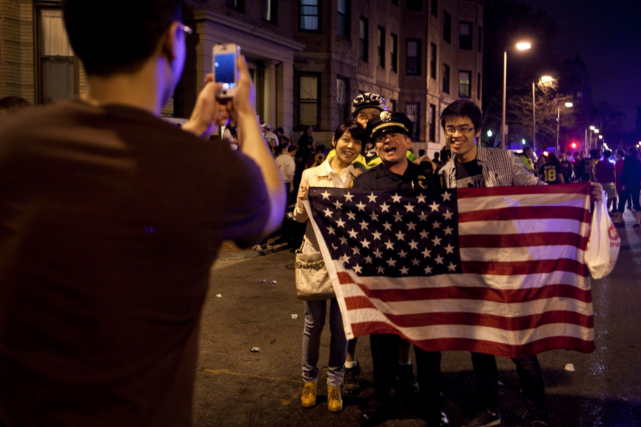 PHOTO: A few of the estimated 200 people who poured onto Hemingway Street in the Fenway neighborhood to celebrate after the announcement earlier of the capture of the second Boston Martathon bombing suspect celebrate April 19, 2013 in Boston, Mass.