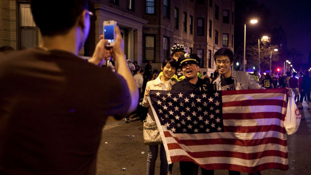 PHOTO: A few of the estimated 200 people who poured onto Hemingway Street in the Fenway neighborhood to celebrate after the announcement earlier of the capture of the second Boston Martathon bombing suspect celebrate April 19, 2013 in Boston, Mass.
