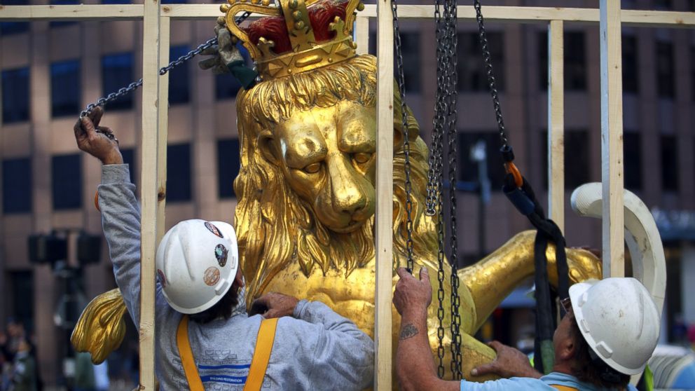 The iconic statues of a lion and a unicorn atop the Old State House on Washington Street in Boston were hoisted down from the rooftop perches they have occupied for over 300, Sept. 14, 2014.