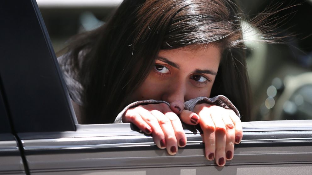 Sydney Corcoran, a victim of the first explosion of the Boston Marathon bombing, looks at her mother, Celeste, from her brother's car that will bring her home after being discharged from Spaulding Rehab Hospital, May 3, 2013.