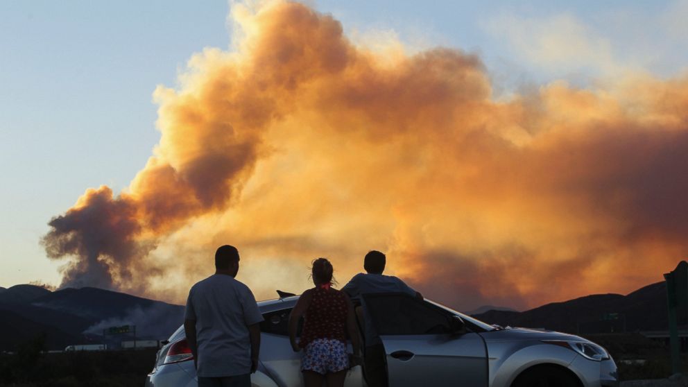 PHOTO: People watch the so-called Blue Cut wildfire in Lytle Creek, California, Aug. 16, 2016.