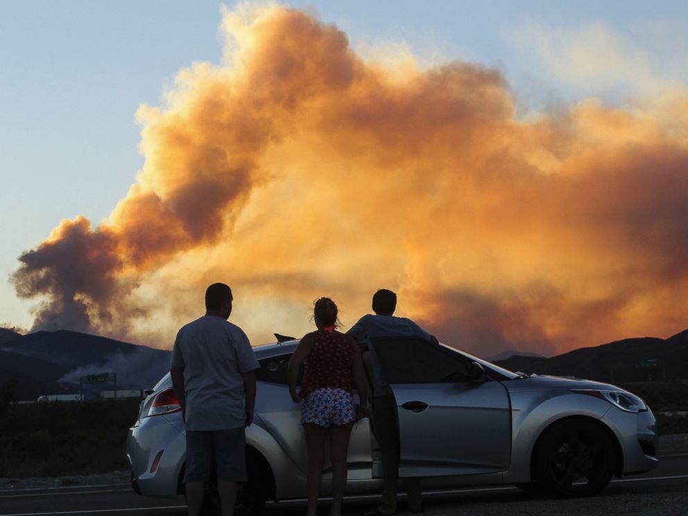 PHOTO: People watch the so-called Blue Cut wildfire in Lytle Creek, California, Aug. 16, 2016.