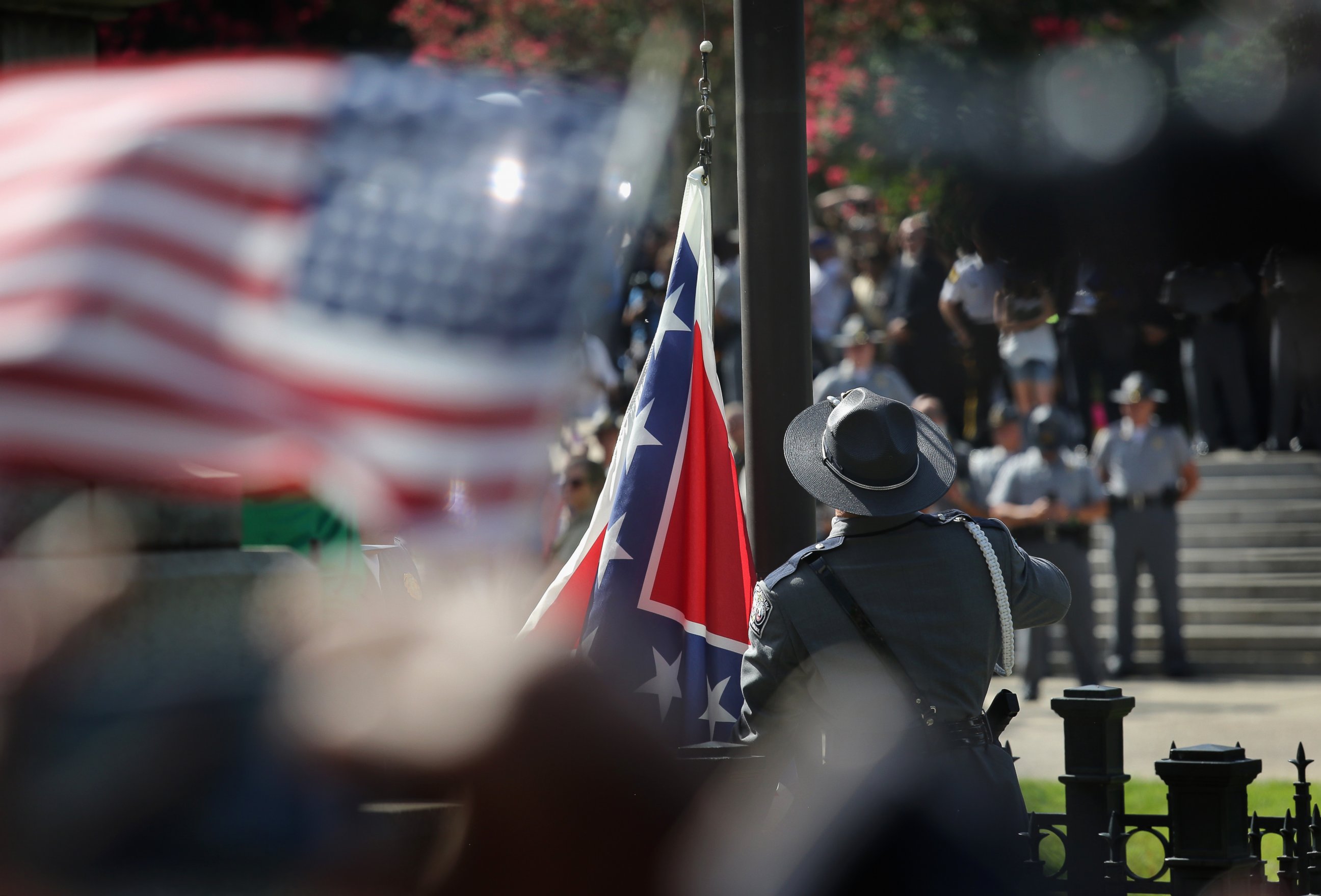 PHOTO: A South Carolina state police honor guard lowers the Confederate flag from the Statehouse grounds on July 10, 2015, in Columbia, S.C.
