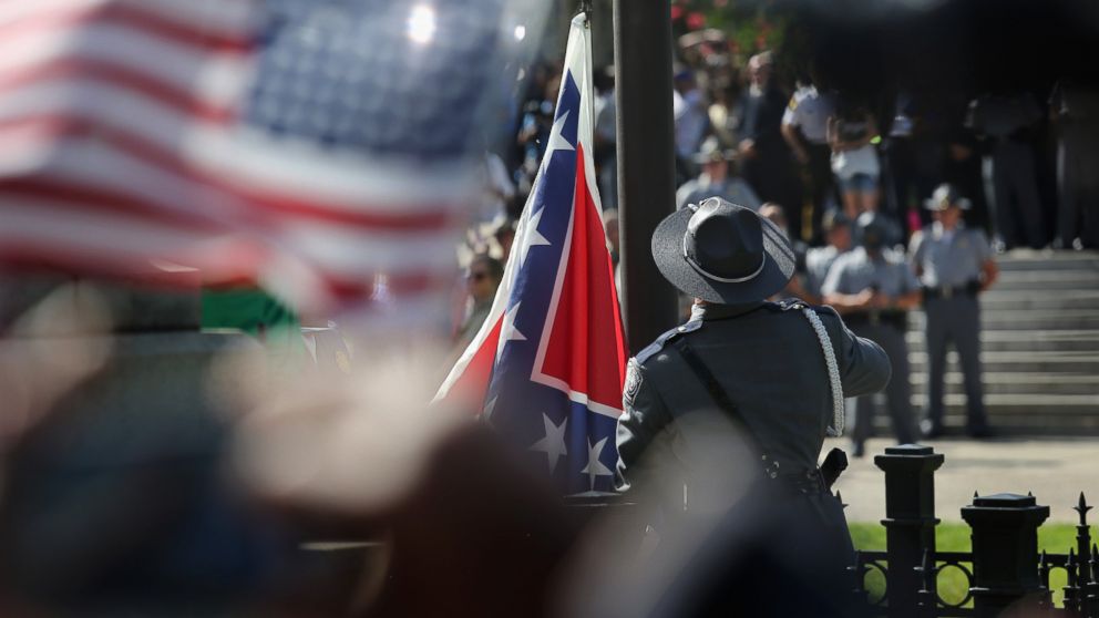 PHOTO: A South Carolina state police honor guard lowers the Confederate flag from the Statehouse grounds on July 10, 2015, in Columbia, S.C.