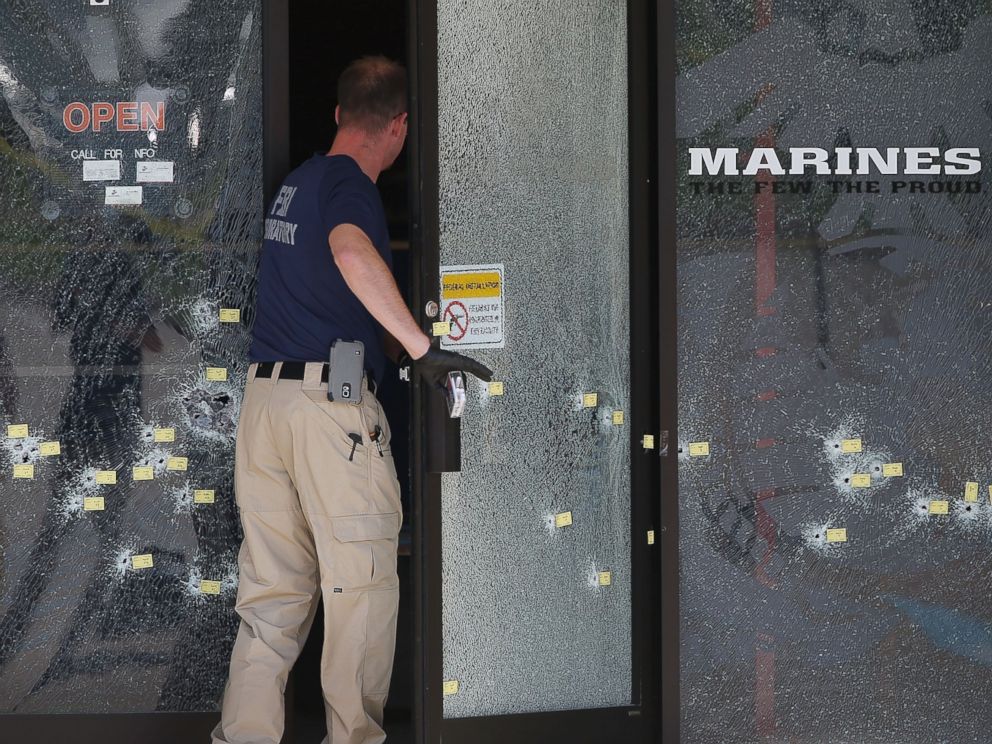 PHOTO: A member of the F.B.I. Evidence Response Team walks through a bullet riddled door as he investigates the shooting at the Armed Forces Career Center/National Guard Recruitment Office, July 17, 2015 in Chattanooga, Tennessee.