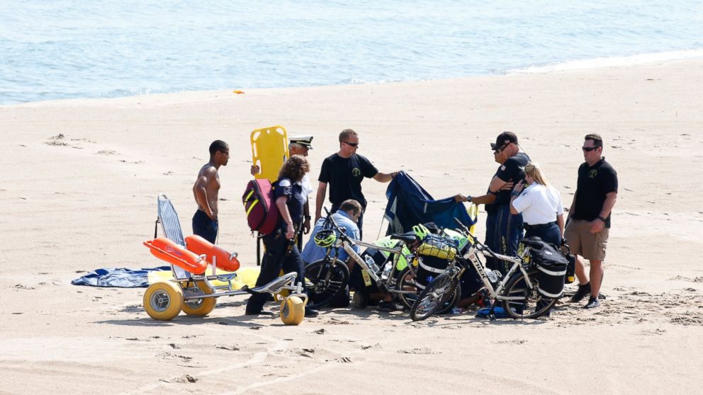 A Navy Leap Frog parachuter receives medical attention on North Avenue Beach on Aug. 15, 2015, after a performance at the first day of the annual Chicago Air & Water Show in Chicago. 